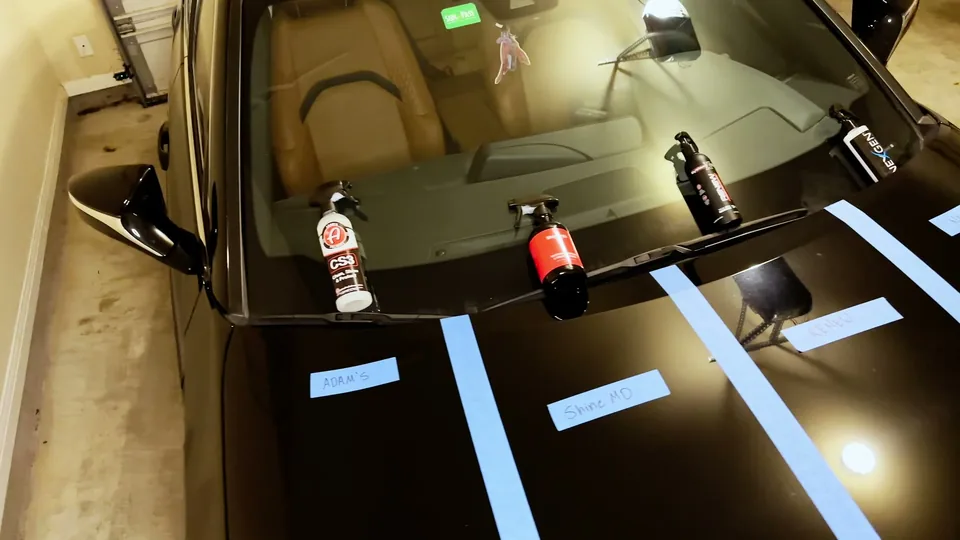 Black car hood masked into four labeled sections with ceramic spray bottles lined along the windshield during our split-panel comparison filming